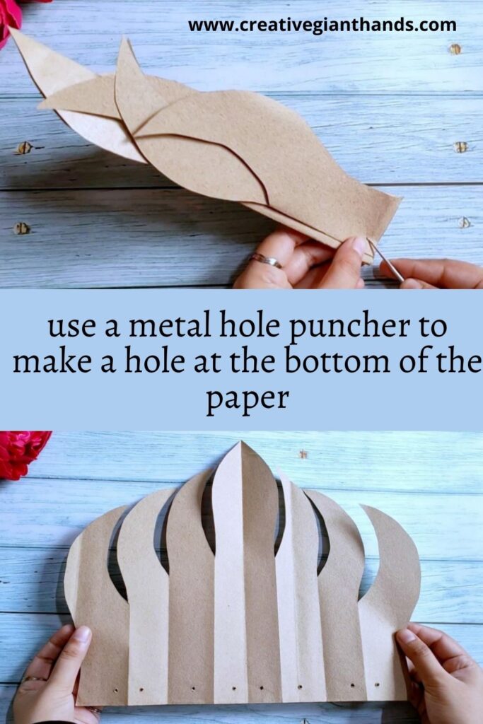 use a metal hole puncher to make a hole at the bottom of the paper