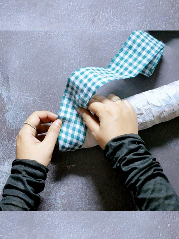 Start wrapping the entire candy cane with fabric to give it a rustic look
